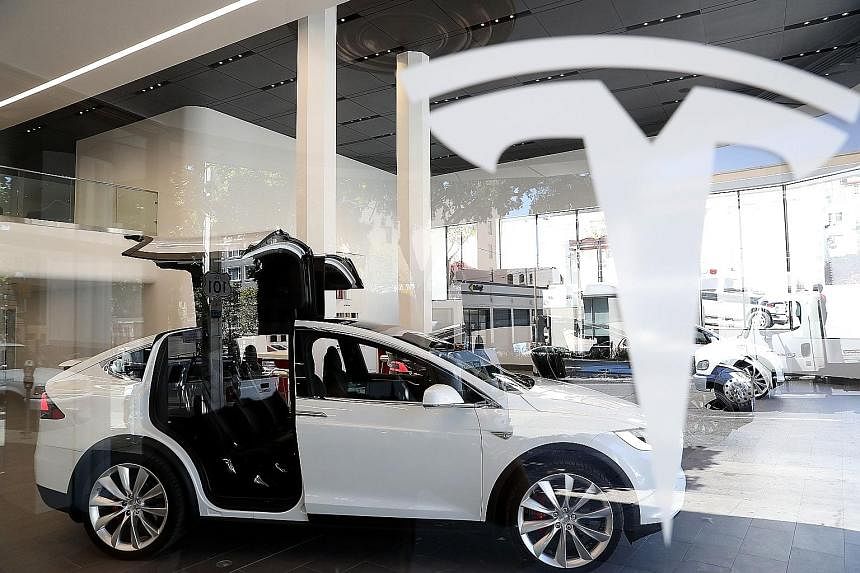 A Model X sport utility vehicle on display at Tesla's flagship facility in San Francisco. The company now appears to be moving beyond systems that assist human drivers, to newer technology that enables fully autonomous driving.