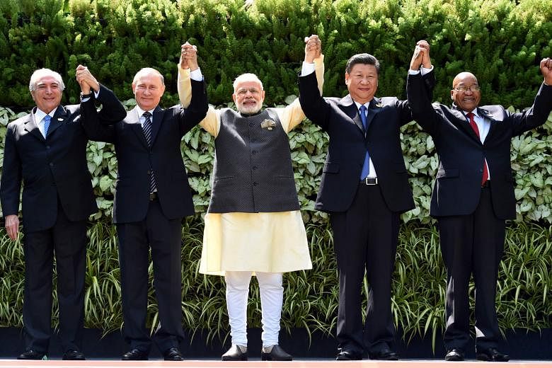 From left: Brazilian President Michel Temer, Russian President Vladimir Putin, Indian Prime Minister Narendra Modi, Chinese President Xi Jinping and South African President Jacob Zuma seen here in a group photo taken on Sunday during a Brics summit in Goa