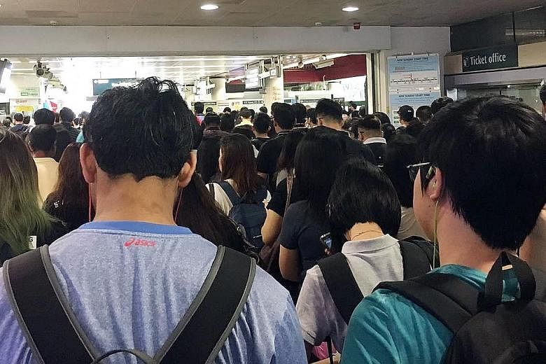 Commuters at Lakeside MRT station during the delay, which was reported at about 7am yesterday.