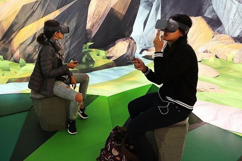 Visitors to the Google pop-up shop in New York trying out the company's new Daydream View virtual reality headset. Nothing is sold at the shop, but it allows people to get their hands on new Google devices such as the Pixel smartphone, the Home virtu