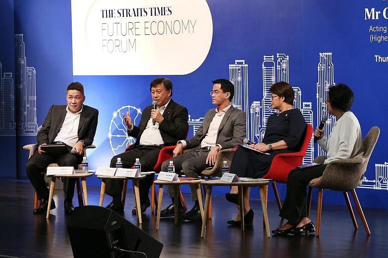Panel members at Thursday's forum were (from left) EY's Mr Loh, DBS Singapore's Mr Sim, Parkway Pantai's Dr Loh, and Shell Singapore's Ms Goh. The moderator was ST's Ms Lee (right).