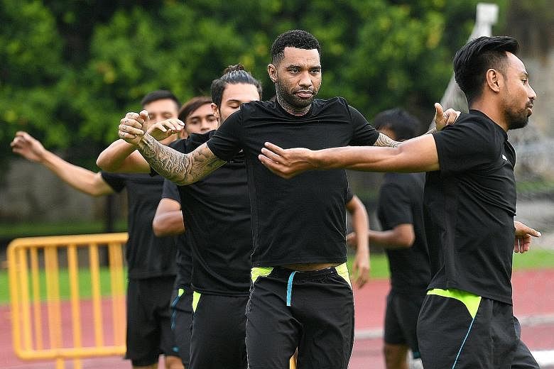 Tampines players including Jermaine Pennant (second front right) training at Jurong West Stadium ahead of tonight's S-League game against Balestier. Both sets of players will be playing for their futures.