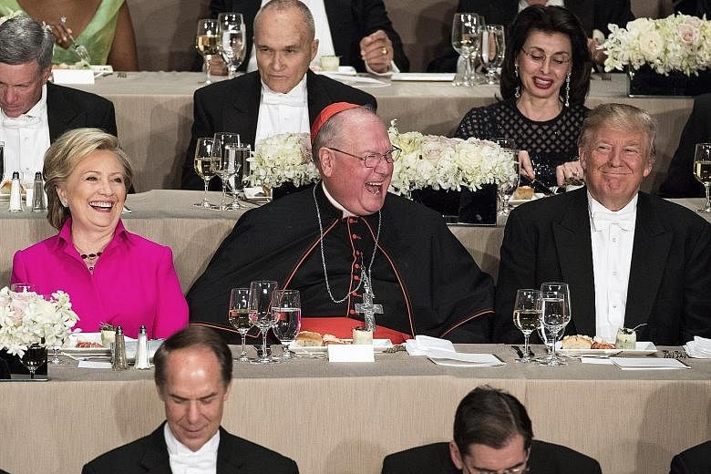 During the Alfred E. Smith Memorial Foundation Dinner in New York on Thursday, Mrs Clinton and Mr Trump sat just a seat apart, separated by Cardinal Timothy Dolan, the archbishop of New York. The annual event, which raises money for needy children, t