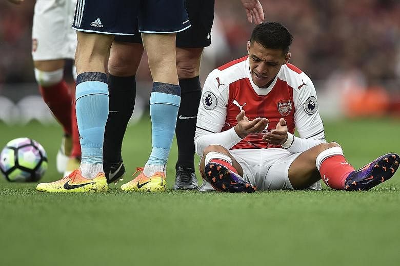 Arsenal forward Alexis Sanchez sitting on the pitch after being fouled during the Gunners' 0-0 draw against Middlesbrough at the Emirates Stadium yesterday. The hosts endured a frustrating match against a stubborn Boro side, and had a goal correctly 