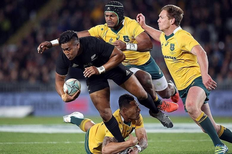 All Black Julian Savea being tackled by Australia's Henry Speight (centre), Bernard Foley (right) and Israel Folau during the third Bledisloe Cup Test at Eden Park. New Zealand won the trans-Tasman clash 37-10.