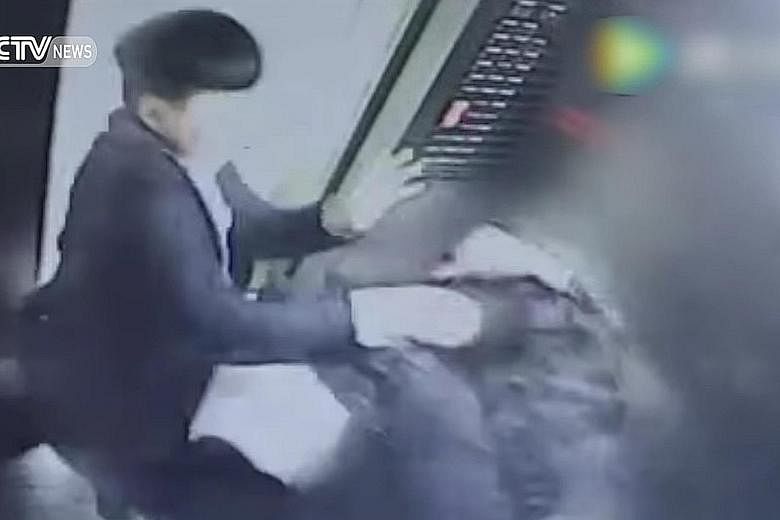 In this CCTV video screengrab of the scene inside the elevator of an apartment building, the man is seen attacking the woman. She said she had asked him to put out his cigarette and smoke in the hallway instead.