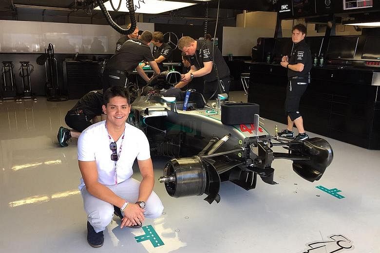 Singapore's Olympic champion Joseph Schooling posing with Formula One world champion Lewis Hamilton's car at the Mercedes GP team garage on Friday. The swimmer was at the Circuit of the Americas in Austin, Texas, as a guest of the Mercedes F1 team an