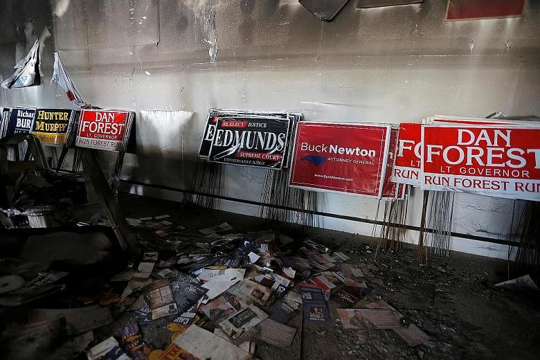 The damage caused by a firebomb attack on the offices of the North Carolina Republican Party earlier this month. The number of hate groups, some espousing violence, and armed militias in the US is rising.