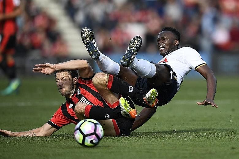Bournemouth's Harry Arter (left) clashing with Tottenham's Victor Wanyama during their English Premier League fixture yesterday. The match ended in a frustrating 0-0 stalemate and Spurs players Erik Lamela and Moussa Sissoko were lucky not to be sent