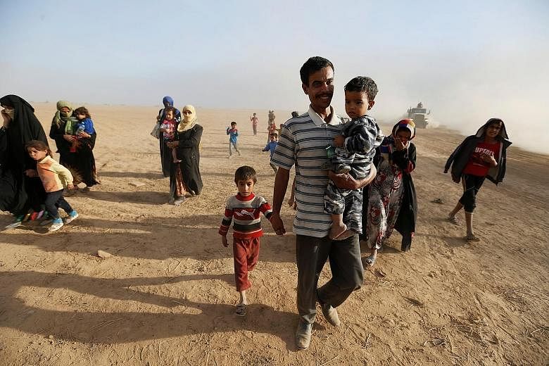 Civilians returning to their village south of Mosul on Friday after it was liberated from ISIS militants. Residents still in Mosul reported that the streets are mostly empty, with ISIS fighters having either fled or moved to the front lines to defend