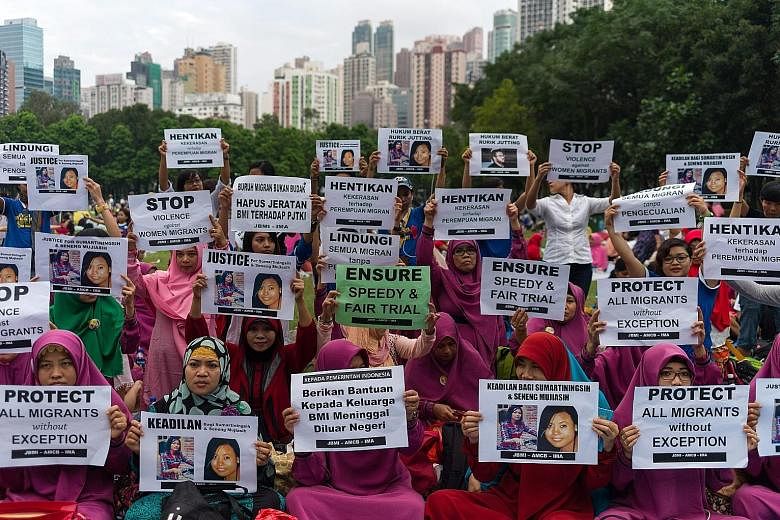 Migrant workers holding a vigil for fellow Indonesians Sumarti Ningsih and Seneng Mujiasih at Victoria Park in Hong Kong yesterday. The two women were stabbed to death in the luxury flat of Briton Rurik George Caton Jutting in November 2014. The form