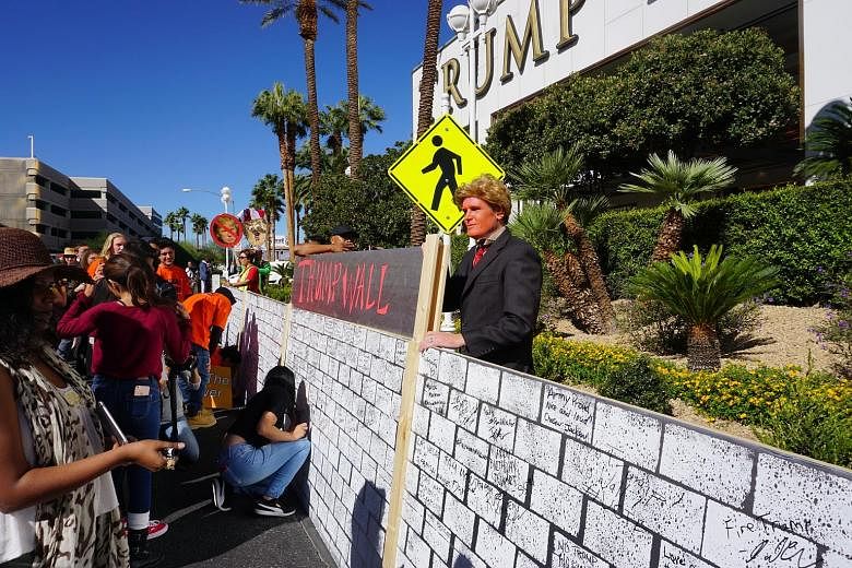 An anti-Trump gathering outside the Trump International Hotel in Las Vegas last week. Current polling puts Democratic candidate Hillary Clinton ahead in Nevada, with The New York Times giving her a 78 per cent chance of clinching the state. Ms Ha sup