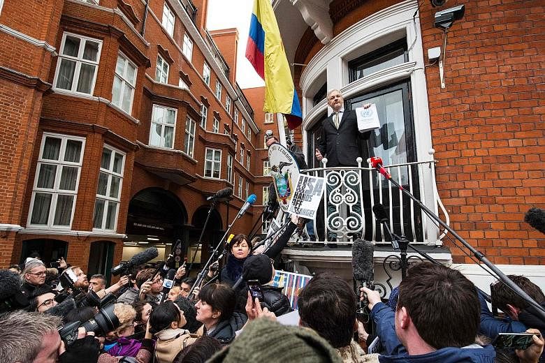 Mr Assange addressing media from the balcony of the Ecuadorean Embassy in London in February. He sought political asylum there in 2012 and has not left the premises since, claiming he could be deported.