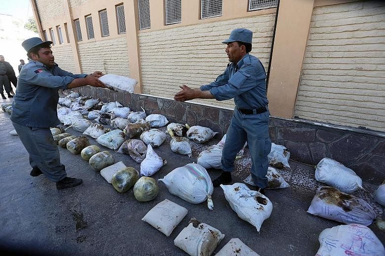 Seized opium displayed in Afghanistan's Herat province. The government blames rising insurgency, favourable weather and lack of international funding for the increase in opium cultivation. The country remains the world's top producer of the drug.