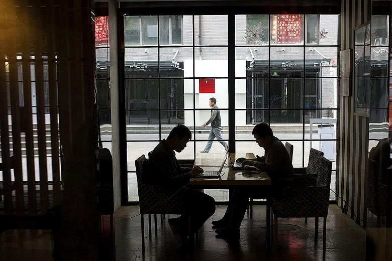 Internet start-up employees working in a cafe in Beijing. The Chinese government's plan to rate people and businesses is officially aimed at fighting fraud, but critics say accumulating so much data on individuals is a move towards a totalitarian soc