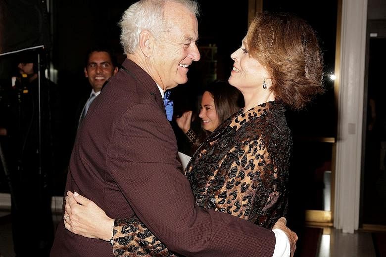 Comedian Bill Murray greets actress Sigourney Weaver (both above) at the Kennedy Center in Washington on Sunday.
