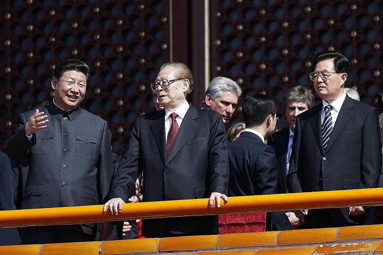 From left: China's President Xi with former leaders Jiang Zemin and Hu Jintao, at a military parade at Tiananmen Square last year. Being named a "core leader" will give Mr Xi a stronger hand to push reforms.