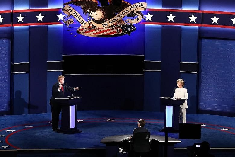 Mr Trump and Mrs Clinton at the third presidential debate in Las Vegas last week. The binary character of US politics is an anachronism in a world where nearly all democracies are now multi-party systems, says an academic.