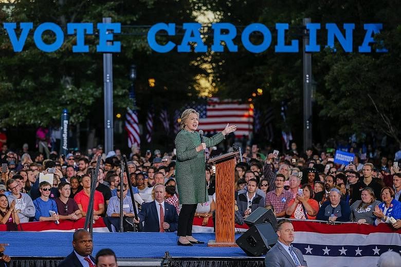 Mrs Clinton at a campaign event at the University of North Carolina in Charlotte on Sunday. She has urged black voters in the state to punish Republican office holders for supporting Mr Trump, even as Mr Trump's party increasingly concedes he is unli