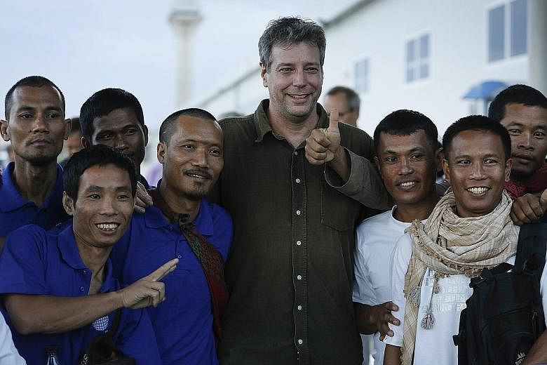 The crew of an Omani-flagged fishing vessel seized nearly five years ago by Somali pirates celebrating their freedom with American writer Michael Scott Moore (centre), who was kidnapped in a separate incident but released in 2014, in Kenya on Sunday.