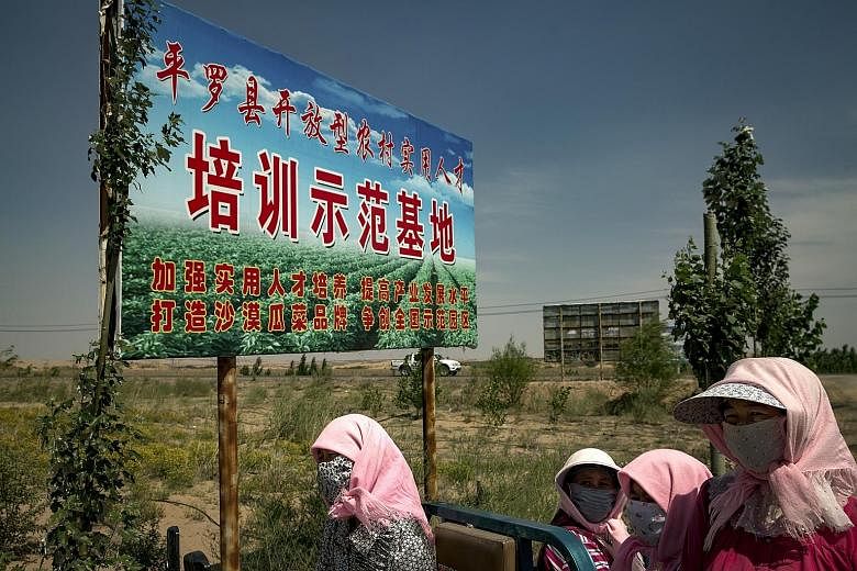 Above: Hui Muslim women working under a signboard promoting a plan for growing watermelons outside Miaomiao Lake Village in China's Ningxia Hui Autonomous Region. Left: Villagers, who were resettled under an environmental and poverty alleviation prog
