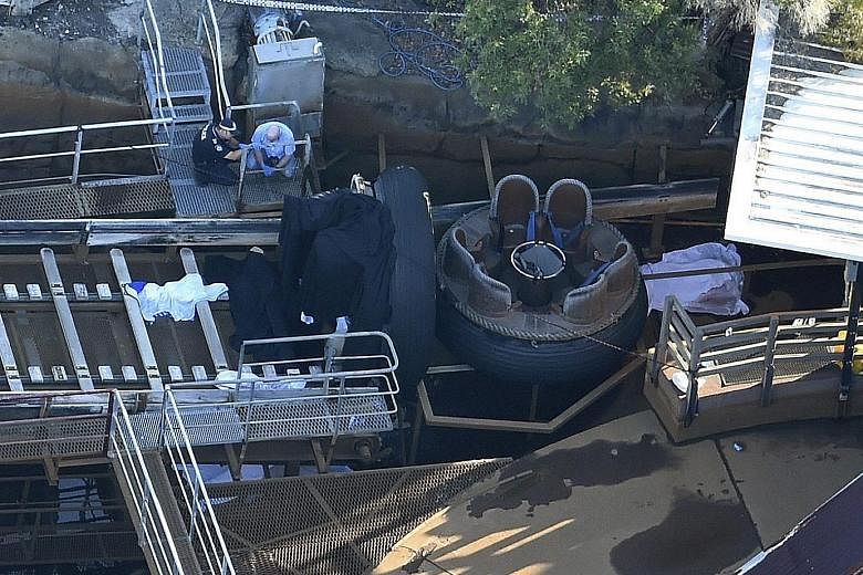 Queensland emergency service staff at the Dreamworld theme park in Gold Coast, Australia, yesterday. The authorities believe there was a problem with the conveyor belt on the Thunder River Rapids ride, which caused a raft to flip over.