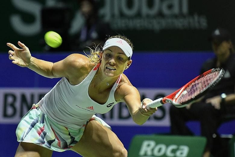 World No. 1 Angelique Kerber at full stretch to retrieve a forehand during her 6-4, 6-2 victory against Simona Halep last night. The German is on the brink of the semi-final stage of the WTA Finals for the first time.