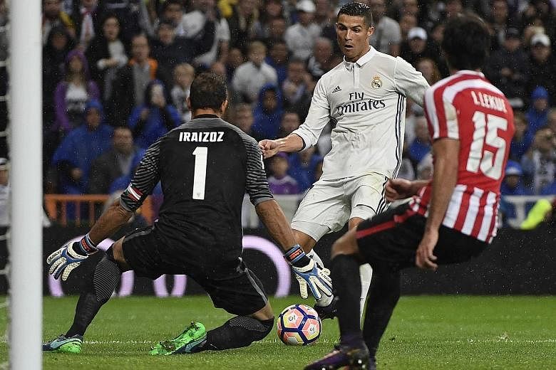 Real Madrid's Cristiano Ronaldo (middle) fails to score against Athletic Bilbao's goalkeeper Gorka Iraizoz during the Spanish league match at the Santiago Bernabeu stadium in Madrid on Sunday. The Portuguese striker was booed after being thwarted twi