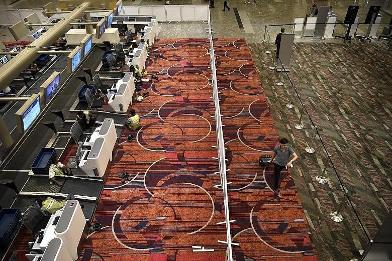 The new check-in rows at Changi Airport Terminal 1 suggest what the departure hall will look like when the upgrading works are complete. More self-service check-in and bag-drop kiosks will also be installed.