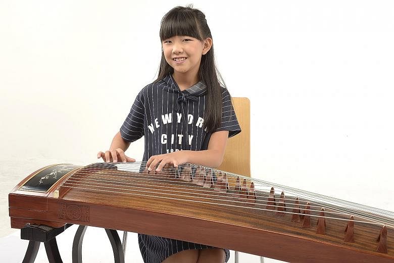 Sylvia Tan (right), an 11-year-old guzheng player, will perform with harp ensemble Rave Harpers, which also features the ChildAid concert's youngest performer this year, six-year-old harpist Kate Ching.