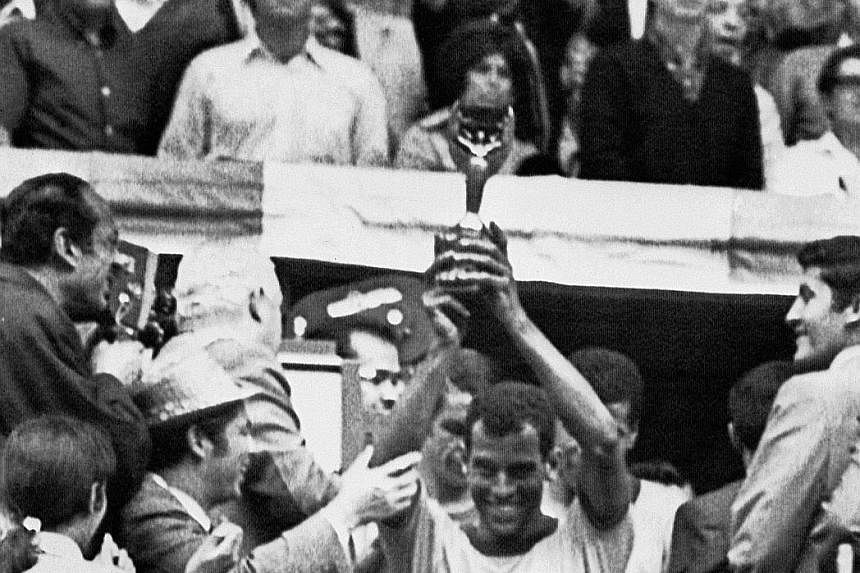 Above: Brazil national football team captain Carlos Alberto holding the Jules Rimet Cup after Brazil beat Italy 4-1 in the 1970 World Cup final in Mexico City. The defender scored Brazil's fourth goal - widely recognised as one of the greatest goals 