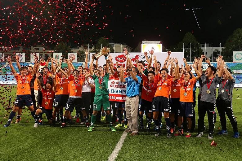 Albirex Niigata's players and staff celebrating with the S-League trophy despite being thrashed 5-1 by Tampines Rovers in the final match of the season at Jalan Besar Stadium last night. The Japanese developmental side had sealed their first S-League