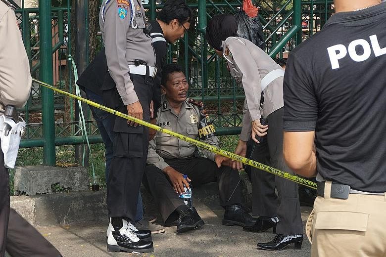 Police officers at a police post in Tangerang, near Jakarta, where a jobless 21-year-old man attacked two officers with knives and pipe bombs last Thursday. The ISIS-linked suspect was shot by a third police officer and died en route to hospital.