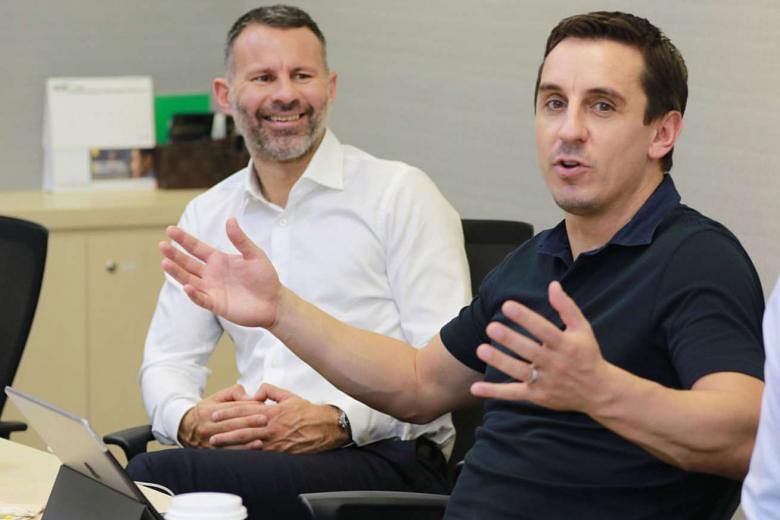 Former Man U stars Ryan Giggs (in white) and Gary Neville at a press briefing yesterday outlining their business plans for Singapore. 