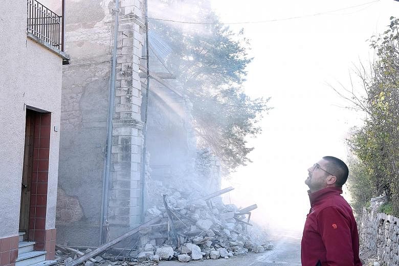 A collapsed building shrouded in dust in Borgo Sant'Antonioyesterday.