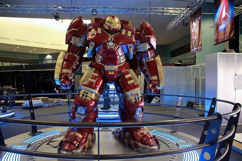 The Hulkbuster supersuit (left) on display at the Marvel's Avengers S.T.A.T.I.O.N exhibition; and an interactive station on the workings of Hulk's brain (far left).