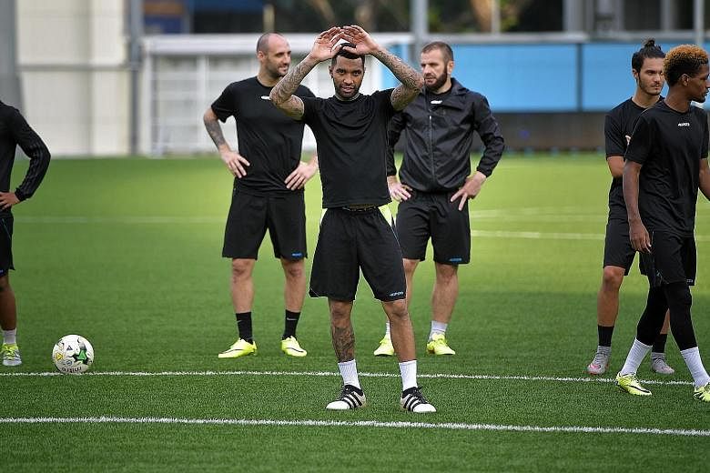 Jermaine Pennant during a break in training yesterday at Jalan Besar Stadium ahead of tomorrow's Singapore Cup final. Behind him are Billy Mehmet (left) and Tampines captain Fahrudin Mustafic.