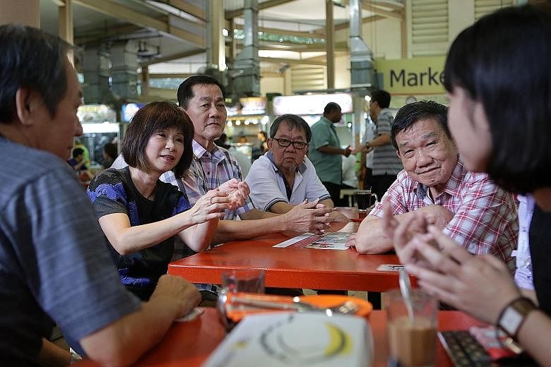 Dr Amy Khor getting feedback from hawkers yesterday to help with the Government's plans for the future of hawker centres.