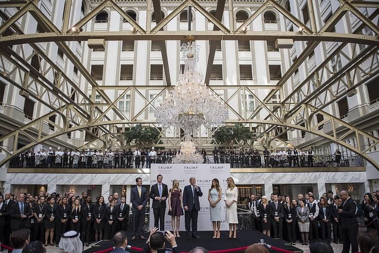 Mr Trump with his wife Melania and children at the grand opening of the Trump International Hotel, which is a stone's throw from the White House, in Washington on Wednesday.