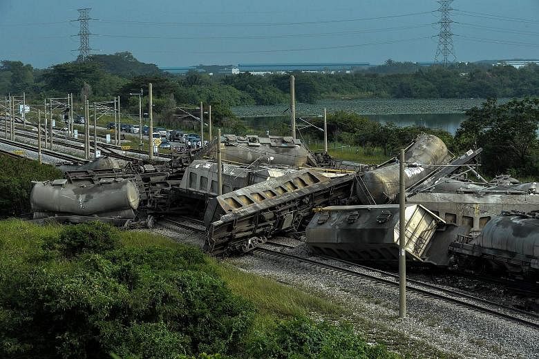 The derailed cargo train near Kampung Bakap in Perak yesterday. The accident affected rail services in the west coast, leading to thousands of stranded commuters. No explanation has been given so far on what caused the derailment. The driver and his 