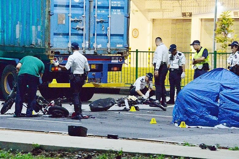 The accident site at the junction of Pandan Crescent yesterday. The 34-year-old driver of the trailer was arrested on suspicion of causing death by negligence. E-bike users Ang Yee Fong and Ong Zi Quan died, while a third, Marcus Loke, sustained inju