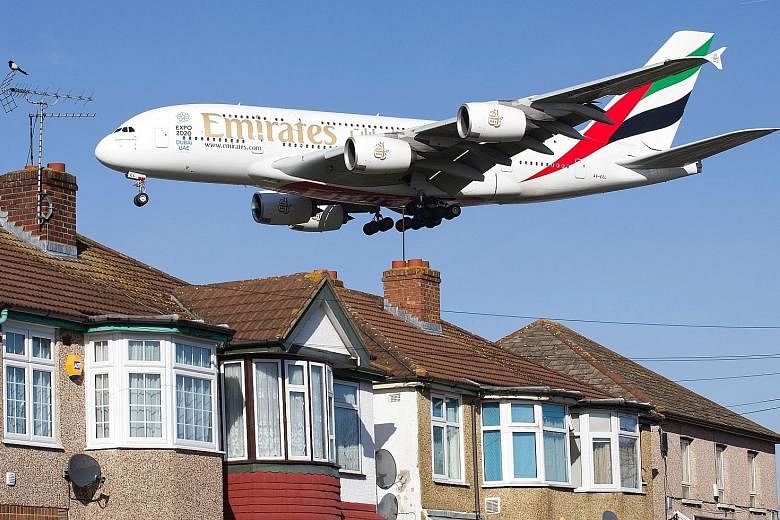 A plane flying low over houses in west London (above) as it prepares to land at Heathrow Airport. The high level of noise caused by the heavy air traffic around Heathrow is one of several reasons people are against its expansion.