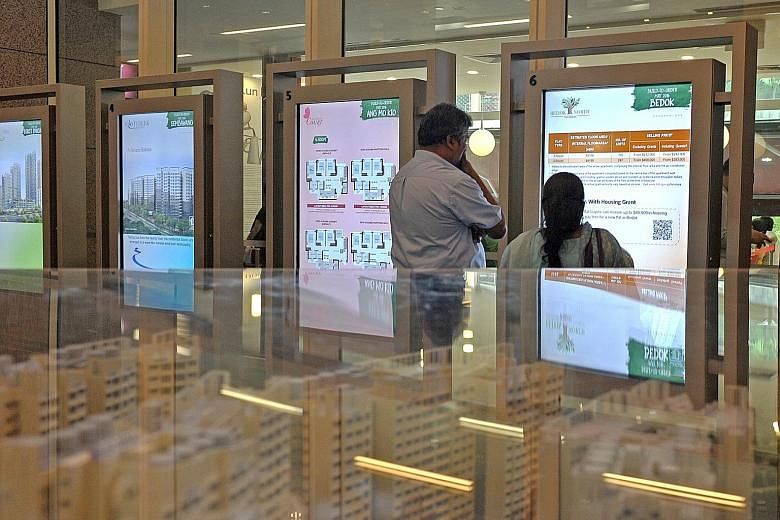 A couple viewing a display of BTO flats at the HDB Hub in Toa Payoh. MND says applicants stand a higher chance of success if they apply for flats in non-mature estates; most are able to secure a flat within two tries.