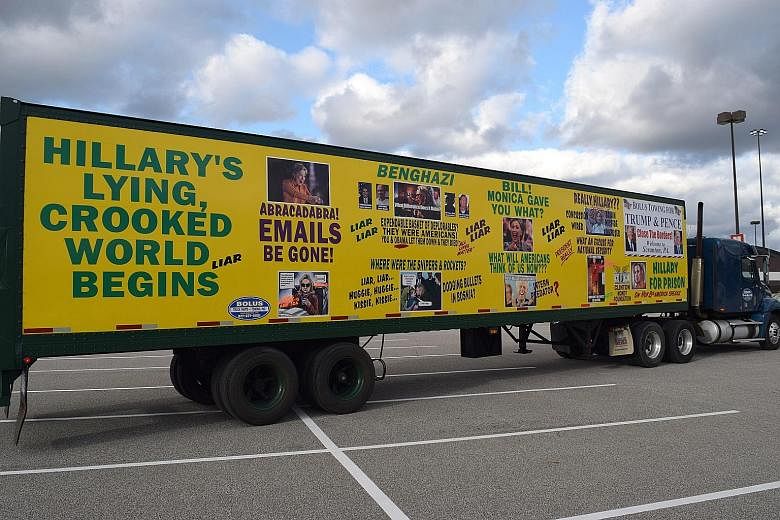 A truck parked at Cleveland's I-X Centre during Mr Donald Trump's rally last Saturday sums up the sentiments of many Republican supporters towards Mrs Hillary Clinton. Brecksville resident Gary Kasmer, who plans to vote for Mr Trump, in front of the 