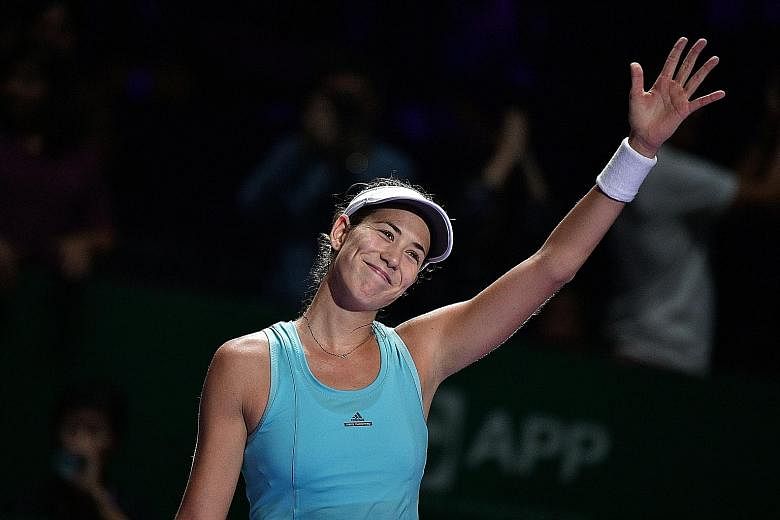 Garbine Muguruza waves to the crowd after beating Svetlana Kuznetsova 3-6, 6-0, 6-1 in her final round-robin match. A semi-finalist last year, the Spaniard is out of this year's competition after two earlier defeats.