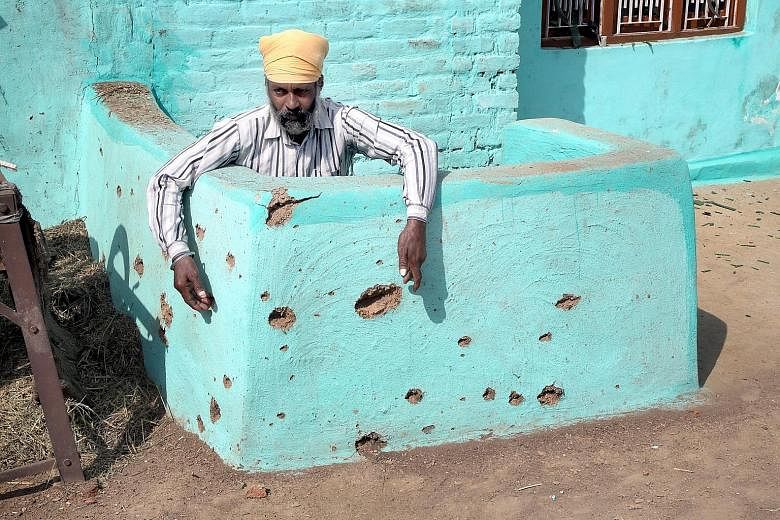 The pockmarked wall of a building damaged by alleged shelling from the Pakistani side of the disputed Kashmir border. Indian and Pakistani troops have exchanged fire several times this week in cross-border shelling.