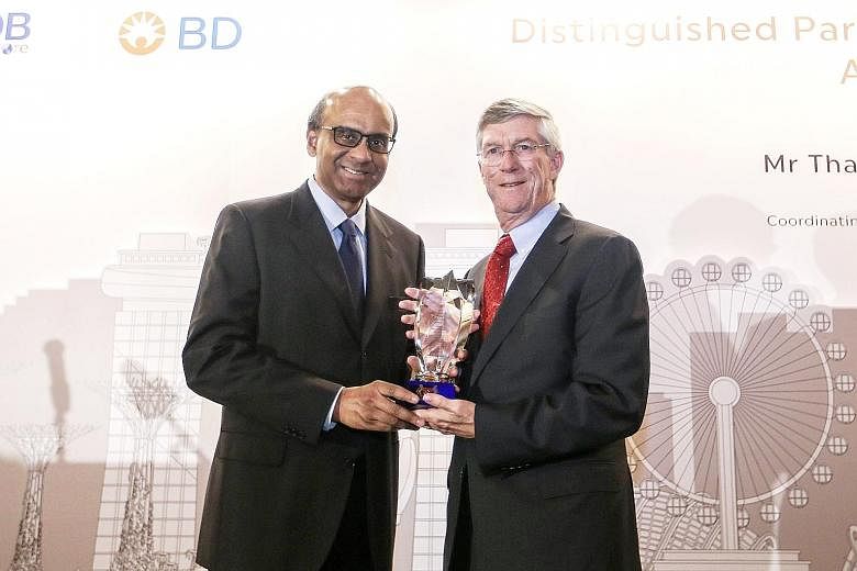 Mr Tharman giving the Distinguished Partner in Progress award to Becton, Dickinson and Company chief executive, Mr Forlenza, at the Mandarin Oriental Hotel yesterday.