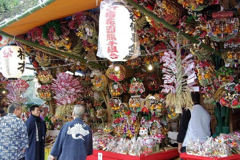 During Tori-no-Ichi, festivalgoers visit Otori-jinja shrines in Tokyo and buy lucky kumade - rakes made of bamboo, sold at stalls (left) around the shrines. In the Cayman Islands, thousands celebrate Pirates Week.