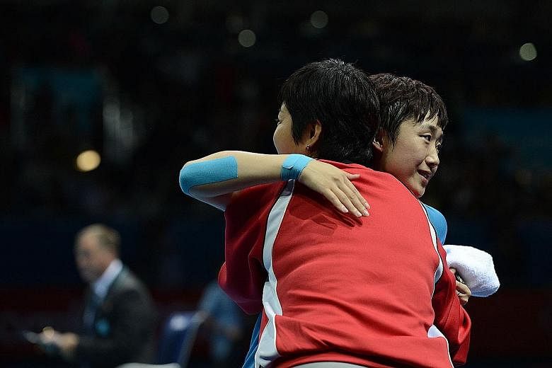 Above: Yang's services were terminated last November, 11/2 years before his contract was up. Left: Feng hugging Jing at the London Olympic Games in 2012. It is understood that the women's team, who had been led by Jing since 2013, had felt that their