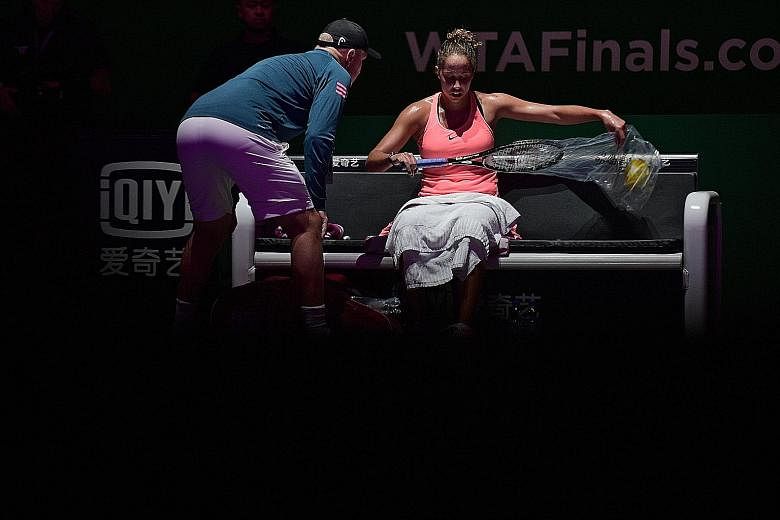 Madison Keys changing to a new racket during her WTA Finals round-robin match on Thursday against Angelique Kerber, while her coach Thomas Hogstedt gives her tips. Although in-game coaching is permitted, some coaches feel that the best players are th